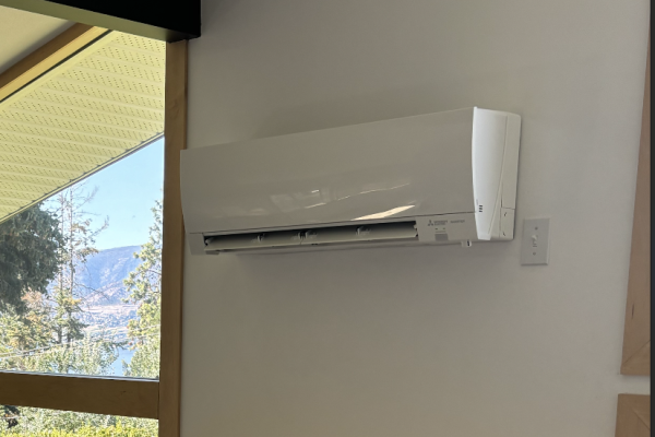 Wall mounted Mitsubishi ductless mini split beside a large window